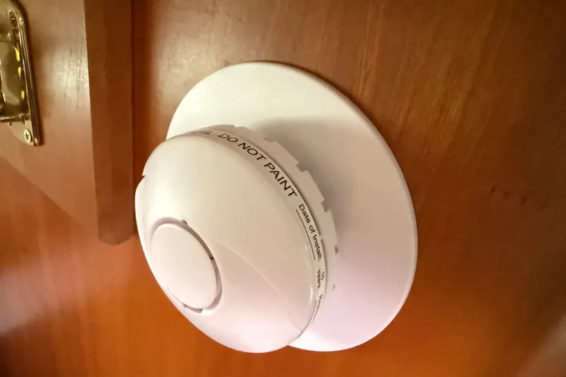 Slide: The Image of Smoke detector on wooden wall inside 2005 Back Cove 26 boat cabin. - 62