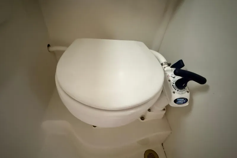 Slide: The Image of Marine toilet in a 2005 Back Cove 26 boat, featuring a Jabsco manual pump. - 65