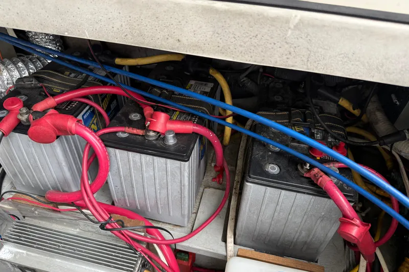 Slide: The Image of Battery compartment of a 2005 Back Cove 26 boat with red and blue cables. - 71