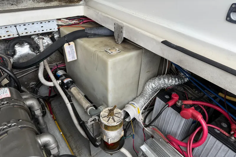 Slide: The Image of Engine compartment of a 2005 Back Cove 26 boat, showing wiring and components. - 72
