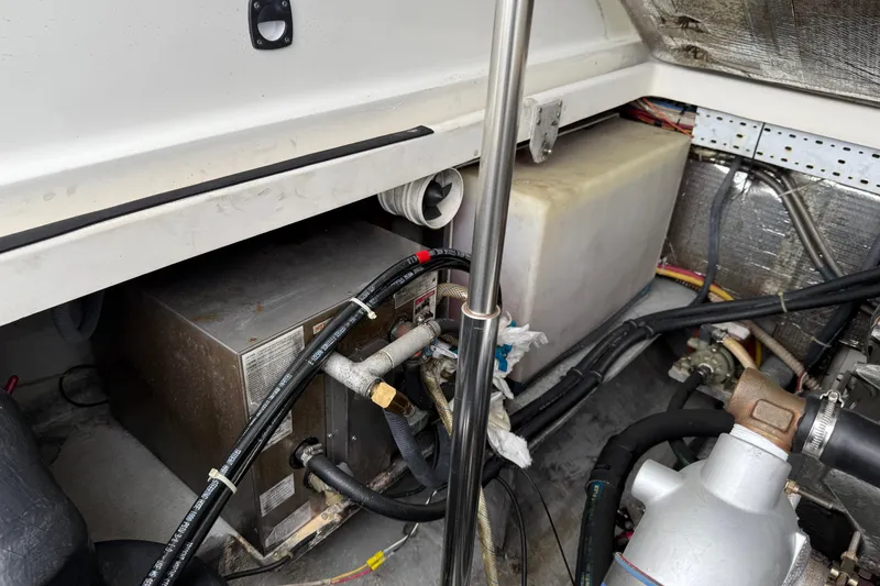 Slide: The Image of Engine compartment of a 2005 Back Cove 26 boat, showing mechanical components and wiring. - 73