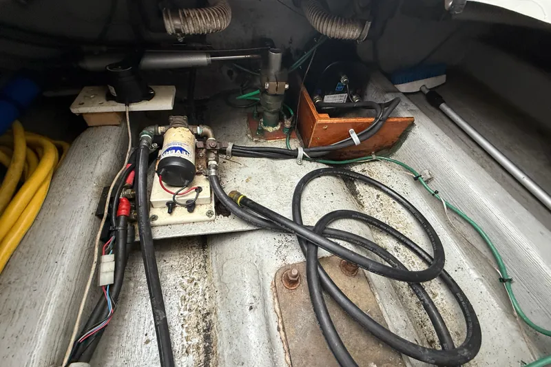 Slide: The Image of 2005 Back Cove 26 boat engine compartment with cables and mechanical components. - 74