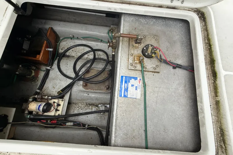 Slide: The Image of 2005 Back Cove 26 engine compartment with wiring and mechanical components visible. - 75