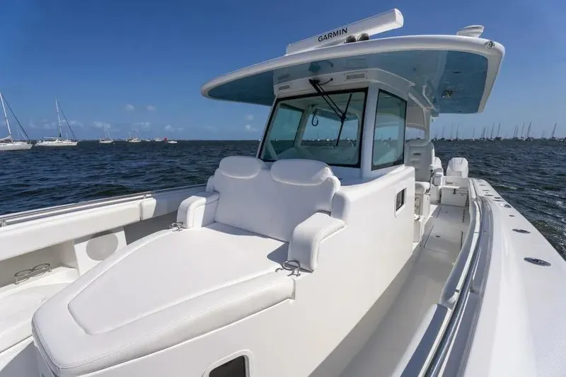 Slide: The Image of 2025 HCB 42 Lujo boat on water, featuring sleek white design and spacious deck. - 11