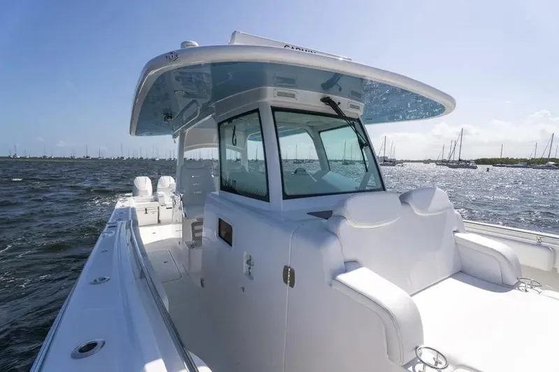 Slide: The Image of 2025 HCB 42 Lujo boat on open water, featuring sleek white design and spacious deck. - 13