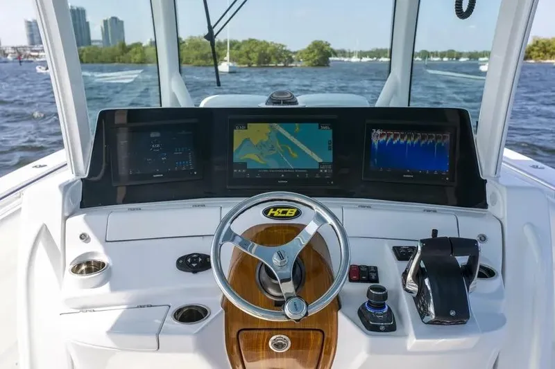 Slide: The Image of Helm of 2025 HCB 42 Lujo boat with advanced navigation displays and controls. - 15