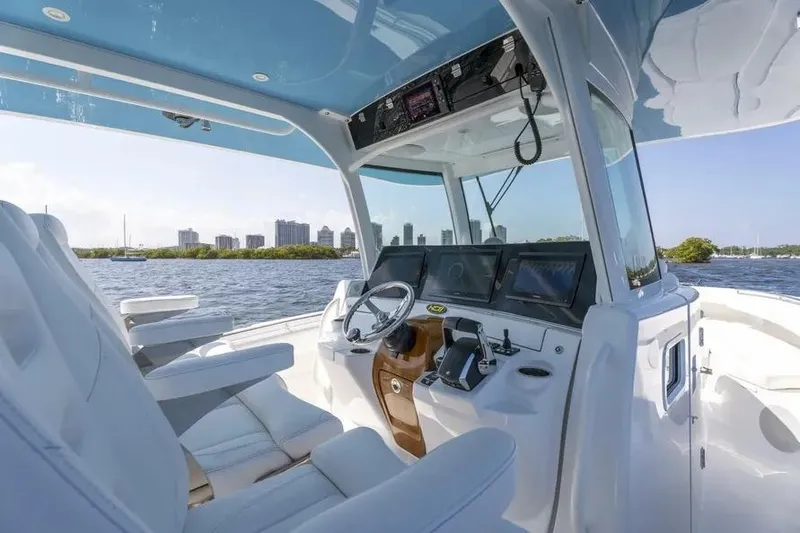 Slide: The Image of Interior view of 2025 HCB 42 Lujo boat, featuring modern helm and luxurious seating. - 16