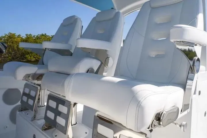 Slide: The Image of Luxury seating on 2025 HCB 42 Lujo boat, featuring sleek white design and modern armrests. - 17