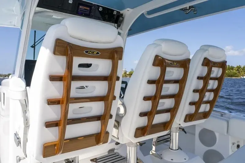 Slide: The Image of Luxury seating on 2025 HCB 42 Lujo boat, featuring elegant wood accents and white upholstery. - 18