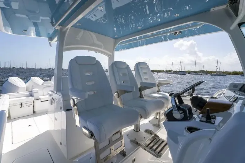 Slide: The Image of Interior view of 2025 HCB 42 Lujo boat with luxurious seating and helm. - 19