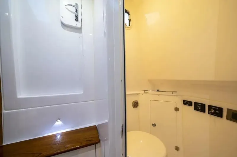 Slide: The Image of 2025 HCB 42 Lujo boat cruising on open water, showcasing sleek design and powerful engines. - 2