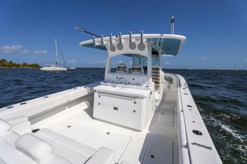 Slide: The Image of 2025 HCB 42 Lujo boat cruising on open water under clear blue sky. - 25