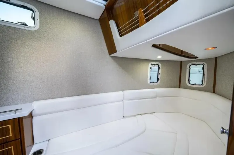 Slide: The Image of Luxurious interior of 2025 HCB 42 Lujo boat with white seating and wood accents. - 26