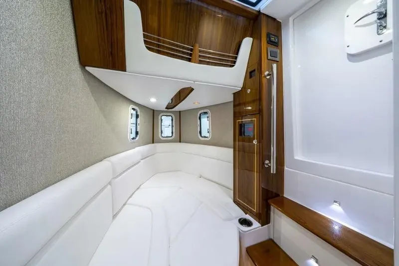 Slide: The Image of Luxurious interior of 2025 HCB 42 Lujo boat with elegant wood and white upholstery. - 27