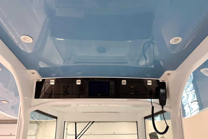 Slide: The Image of Interior view of 2025 HCB 42 Lujo boat, featuring sleek blue ceiling and control panel. - 33