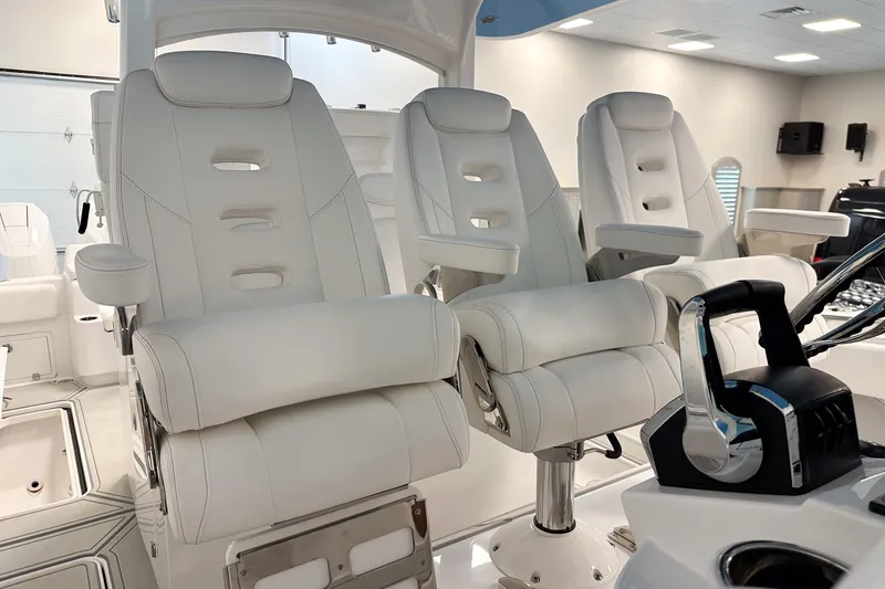 Slide: The Image of Luxury seating on 2025 HCB 42 Lujo boat, featuring sleek white design and modern controls. - 35