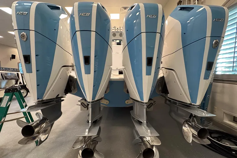 Slide: The Image of 2025 HCB 42 Lujo boat with four powerful outboard engines in a showroom. - 36