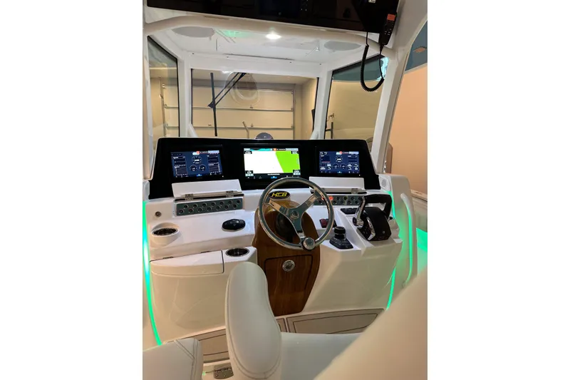 Slide: The Image of Helm of 2025 HCB 42 Lujo boat with advanced navigation displays and controls. - 47