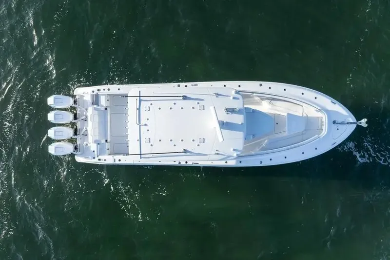 Slide: The Image of 2025 HCB 42 Lujo boat cruising on open water under clear skies. - 5