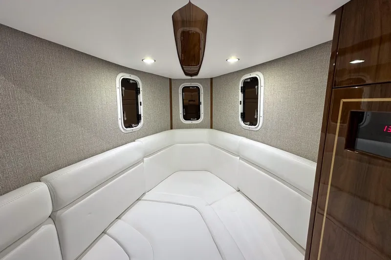 Slide: The Image of Luxurious interior of 2025 HCB 42 Lujo boat with white seating and wood accents. - 55