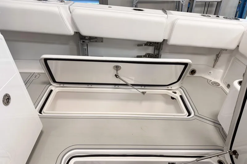 Slide: The Image of 2025 HCB 42 Lujo boat interior with open storage compartment, showcasing sleek design. - 57