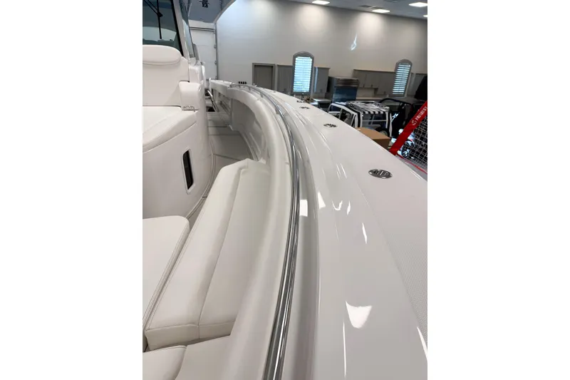 Slide: The Image of 2025 HCB 42 Lujo boat interior with sleek white seating and polished railings. - 58