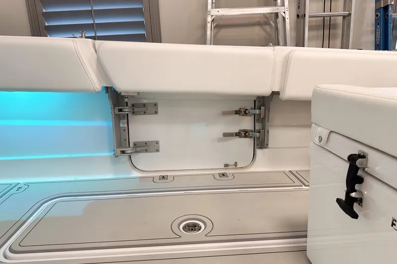 Slide: The Image of Interior view of 2025 HCB 42 Lujo boat, featuring white seating and storage compartments. - 63