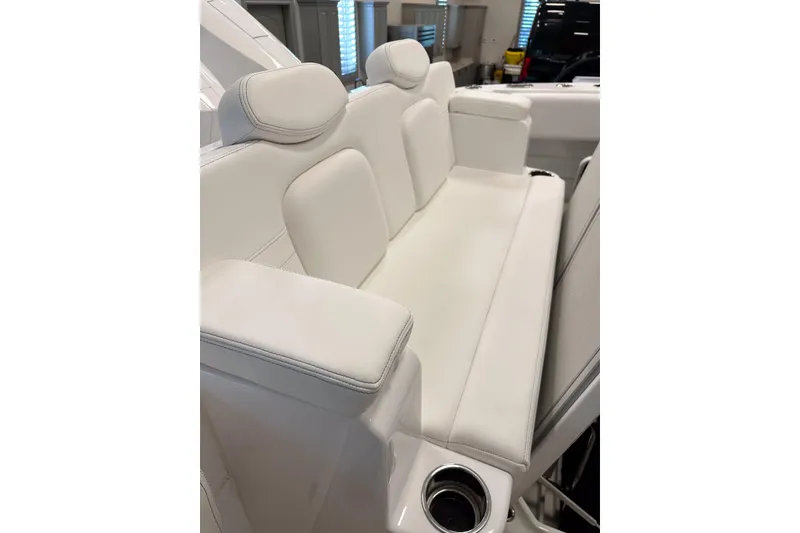 Slide: The Image of Luxurious white seating on 2025 HCB 42 Lujo boat, featuring comfortable cushions and cup holders. - 68