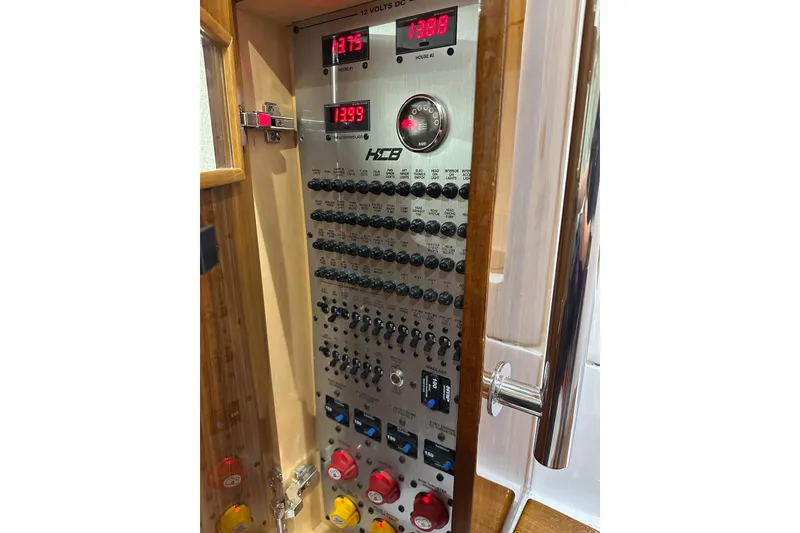 Slide: The Image of Electrical control panel of 2025 HCB 42 Lujo boat with switches and voltage displays. - 74