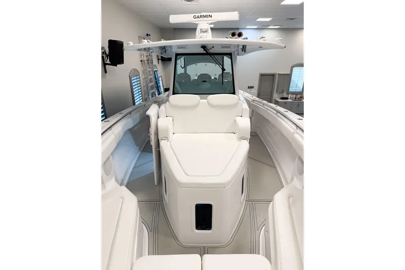 Slide: The Image of 2025 HCB 42 Lujo boat interior with white seating and Garmin equipment. - 75