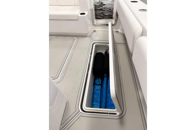Slide: The Image of 2025 HCB 42 Lujo boat interior with open storage compartment and neatly arranged towels. - 77