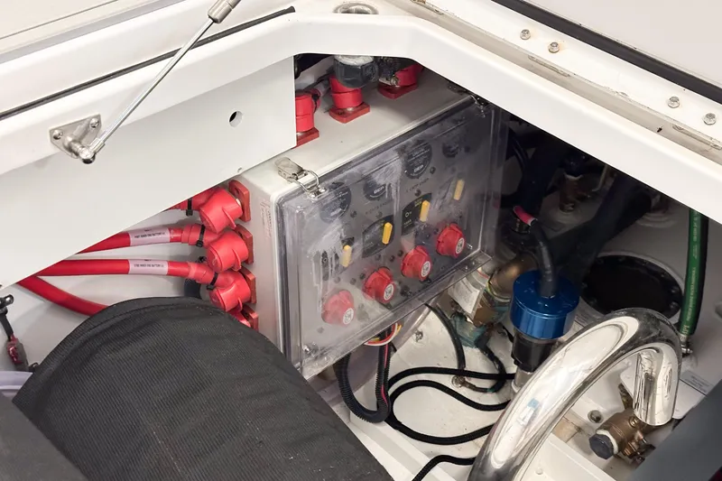 Slide: The Image of Electrical panel inside 2025 HCB 42 Lujo boat, featuring red cables and control switches. - 78