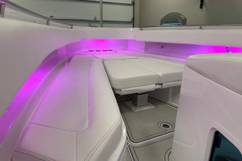 Slide: The Image of 2025 HCB 42 Lujo boat interior with purple LED lighting and white seating. - 81