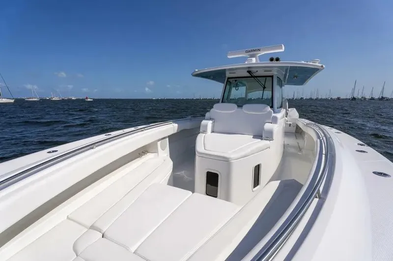 Slide: The Image of 2025 HCB 42 Lujo boat on open water, featuring sleek white design and spacious seating. - 9
