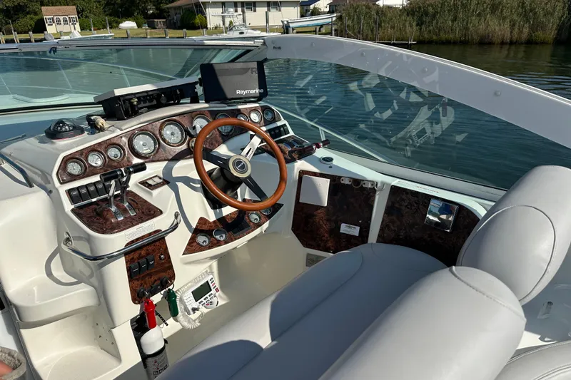 Slide: The Image of Cockpit of 2000 Doral 360 SE boat with wooden steering wheel and navigation instruments. - 11