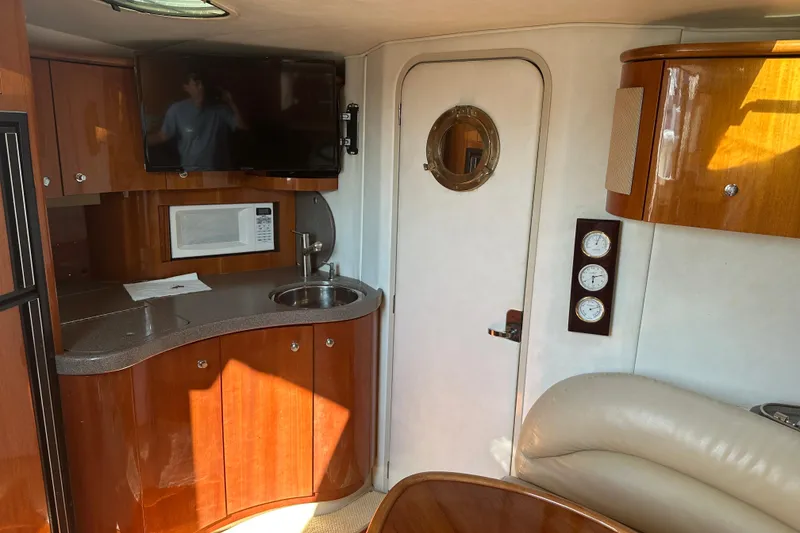 Slide: The Image of Interior of 2000 Doral 360 SE yacht with wooden table and spiral staircase. - 16