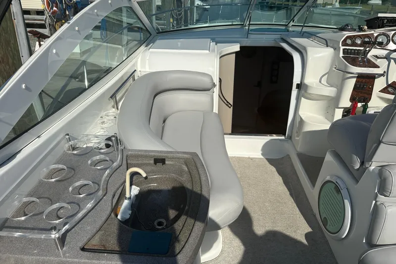 Slide: The Image of 2000 Doral 360 SE boat with seating area and table on deck. - 5