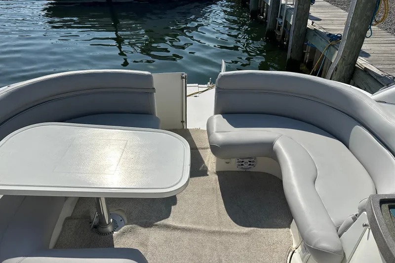 Slide: The Image of 2000 Doral 360 SE boat docked by waterfront homes, showcasing sleek design and spacious deck. - 6