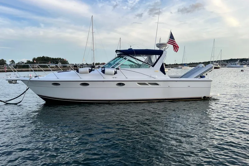 The Image of 2003 Tiara Yachts 3100 Open cruising on the ocean with American flags. - 0