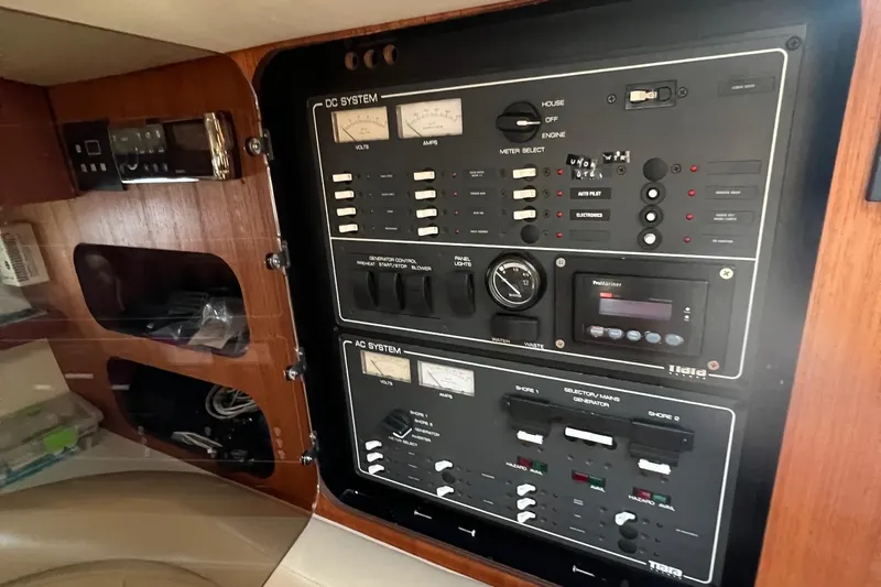 Slide: The Image of Control panel of a 2003 Tiara Yachts 3100 Open, featuring switches and navigation equipment. - 11