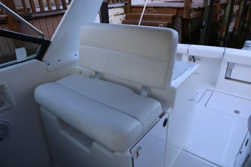 Slide: The Image of 2003 Tiara Yachts 3100 Open, white cushioned seating area on deck. - 22