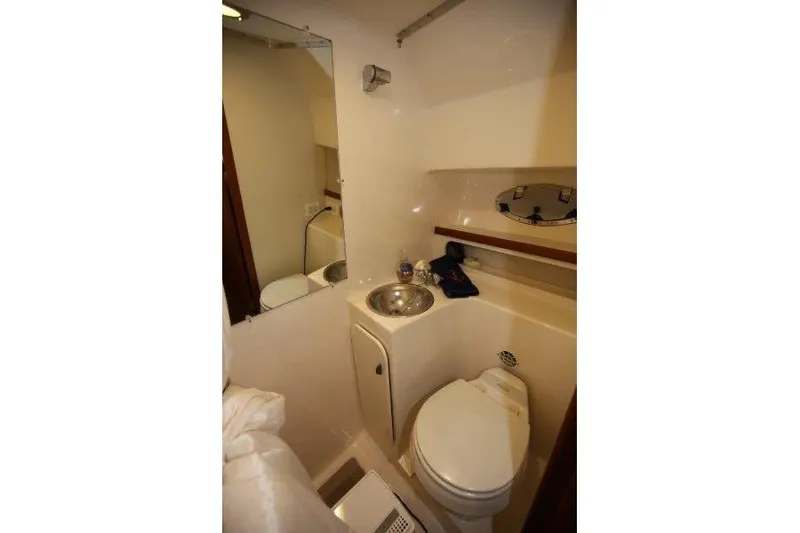Slide: The Image of Interior of 2003 Tiara Yachts 3100 Open, featuring cozy bed and mounted TV. - 28