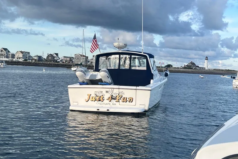 Slide: The Image of 2003 Tiara Yachts 3100 Open at sunset, anchored in a serene harbor. - 3