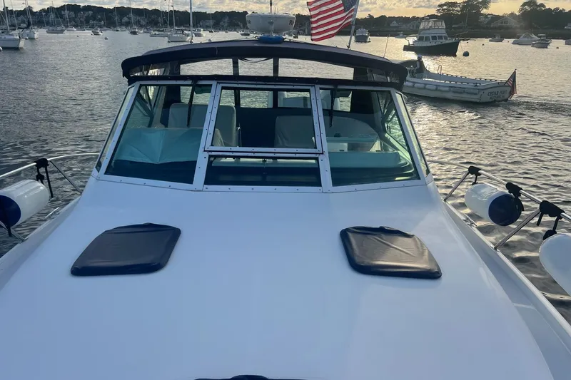 Slide: The Image of 2003 Tiara Yachts 3100 Open deck with hatches, on calm water. - 5