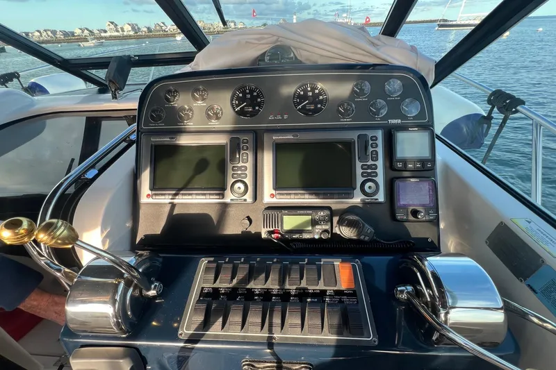 Slide: The Image of 2003 Tiara Yachts 3100 Open interior with white seating, overlooking marina. - 8