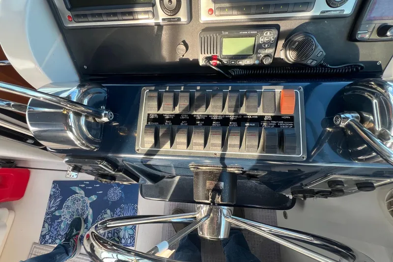 Slide: The Image of 2003 Tiara Yachts 3100 Open dashboard with navigation screens and waterway view. - 9