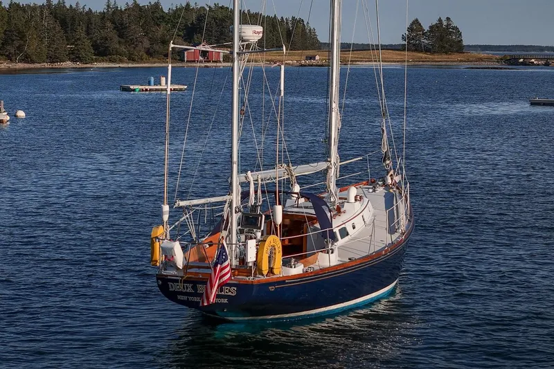 Slide: The Image of 1971 Hinckley Bermuda 40 Custom Yawl sailing in a serene coastal setting. - 14