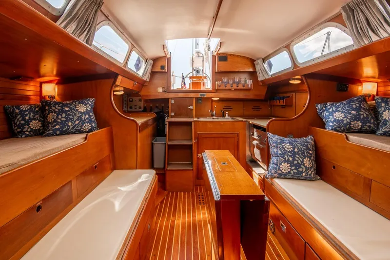 Slide: The Image of Interior of 1971 Hinckley Bermuda 40 Custom Yawl, featuring wooden finishes and cozy seating. - 23