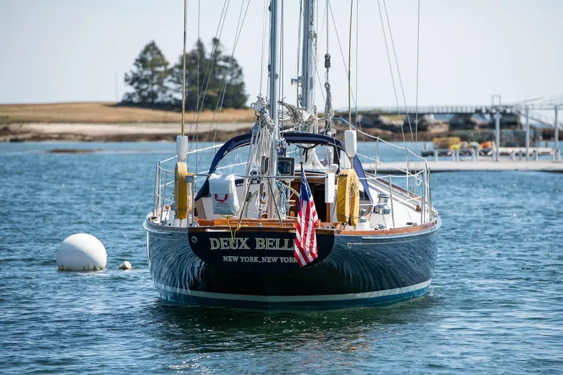 Slide: The Image of 1971 Hinckley Bermuda 40 Custom Yawl sailing in calm waters, rear view. - 5
