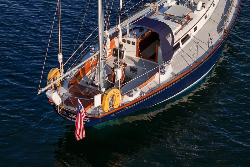Slide: The Image of 1971 Hinckley Bermuda 40 Custom Yawl sailing on calm blue waters. - 15